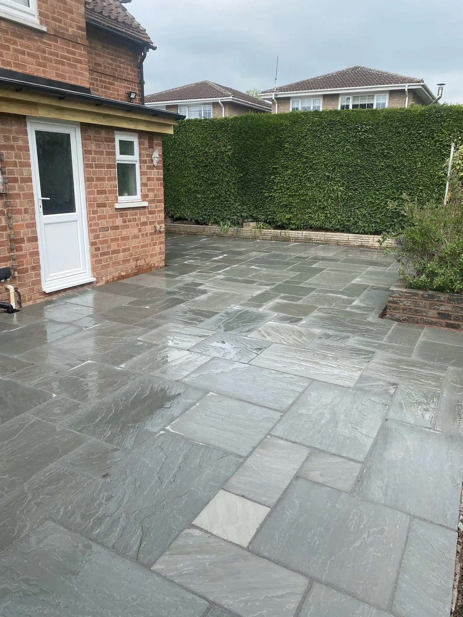 Completed patio and landscaping work showing beautiful outdoor living space